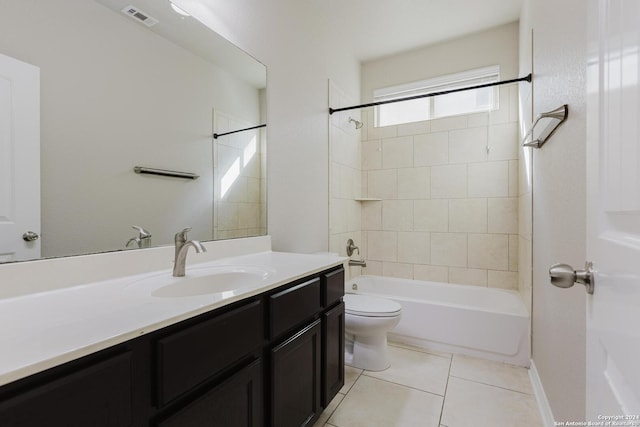 full bathroom featuring toilet, tiled shower / bath combo, vanity, and tile patterned floors