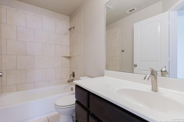 full bathroom featuring tile patterned floors, vanity, a textured ceiling, toilet, and tiled shower / bath