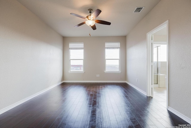 empty room featuring dark hardwood / wood-style flooring and ceiling fan