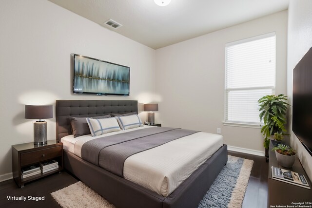 bedroom with dark wood-type flooring