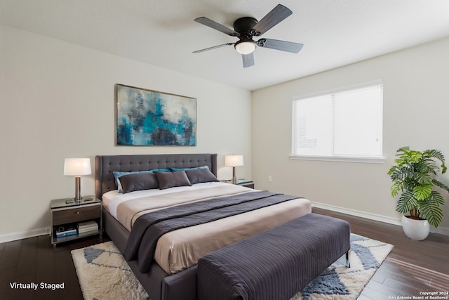 bedroom with dark hardwood / wood-style flooring and ceiling fan