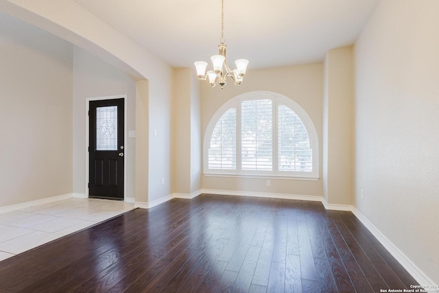 foyer featuring hardwood / wood-style flooring and a chandelier