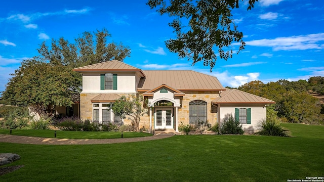 mediterranean / spanish house with french doors and a front yard