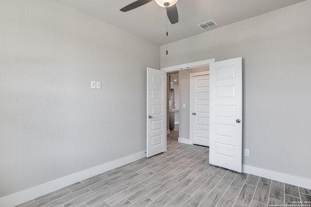 unfurnished bedroom featuring light wood-type flooring and ceiling fan