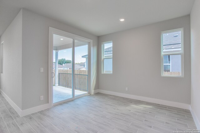 empty room with light hardwood / wood-style flooring