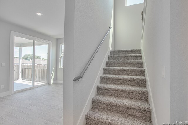 stairs featuring hardwood / wood-style flooring