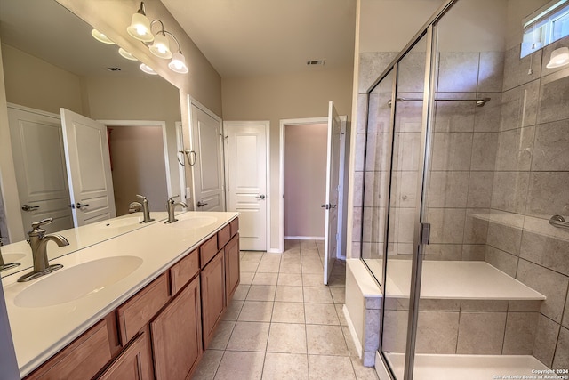 bathroom featuring vanity, tile patterned flooring, and a shower with door