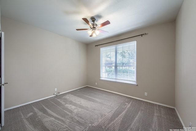 carpeted spare room featuring ceiling fan