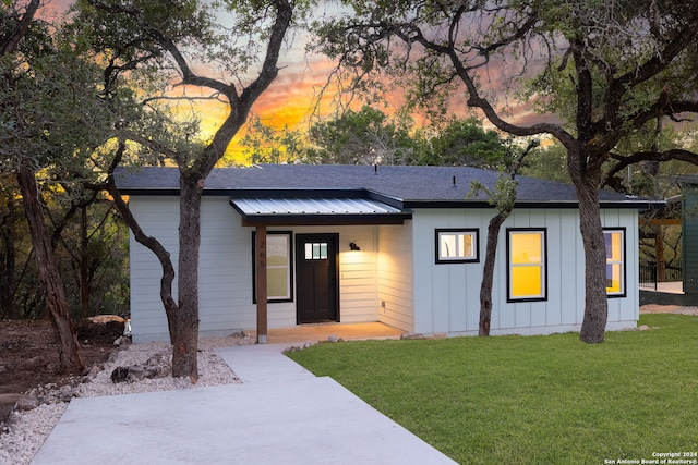 view of front of home with a yard