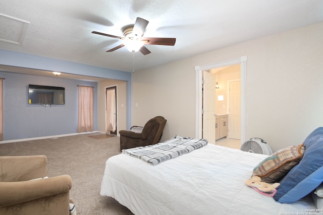 carpeted bedroom featuring ceiling fan and a textured ceiling