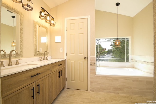 bathroom with vanity and a relaxing tiled tub