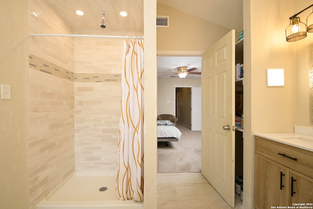 bathroom featuring vanity, vaulted ceiling, curtained shower, and ceiling fan