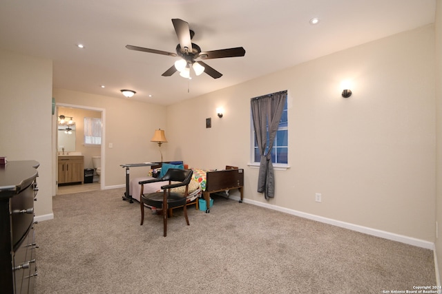 interior space with ceiling fan and light colored carpet