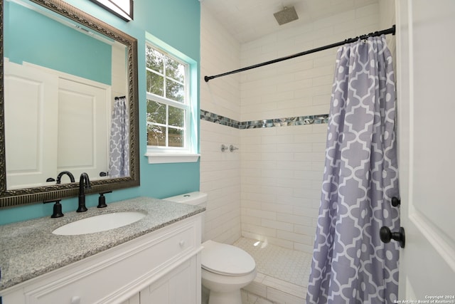 bathroom with vanity, walk in shower, toilet, and tile patterned flooring