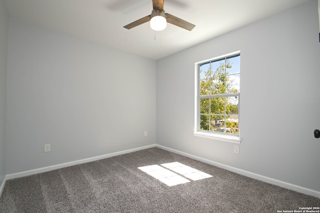 carpeted empty room featuring ceiling fan