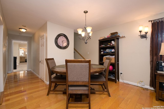 dining room with an inviting chandelier and light wood-type flooring