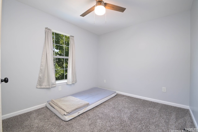 unfurnished bedroom featuring carpet and ceiling fan