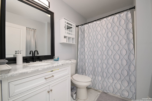 bathroom featuring vanity, walk in shower, and toilet