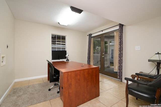 tiled office space with french doors and a textured ceiling