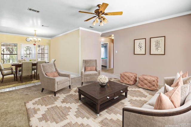 living room with light colored carpet, crown molding, and ceiling fan with notable chandelier