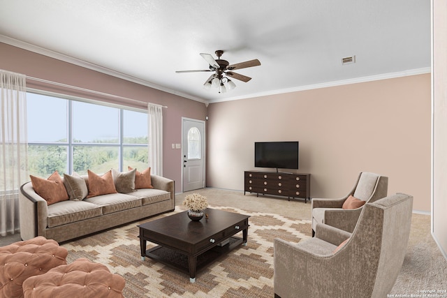 carpeted living room with crown molding and ceiling fan