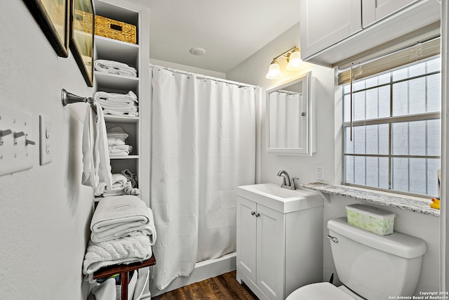 bathroom featuring vanity, hardwood / wood-style floors, a shower with shower curtain, and toilet