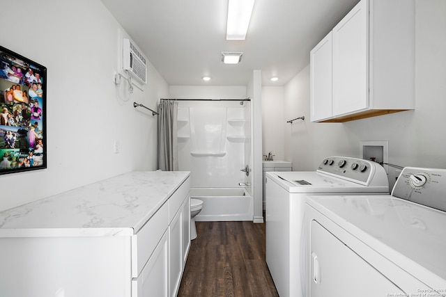 laundry room with sink, a wall mounted AC, washer and clothes dryer, and dark hardwood / wood-style flooring