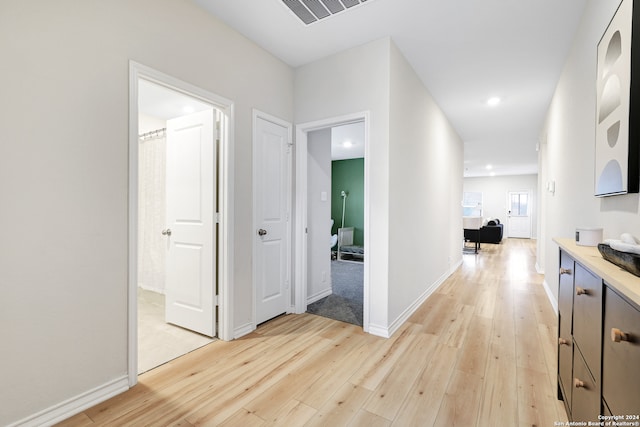 corridor with light hardwood / wood-style flooring