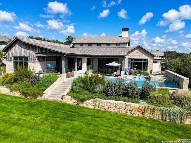 rear view of house featuring a patio area and a lawn