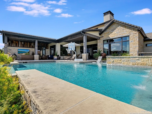 view of swimming pool with a patio area and pool water feature