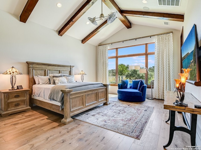 bedroom with light hardwood / wood-style floors and vaulted ceiling with beams