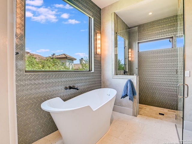 bathroom featuring separate shower and tub