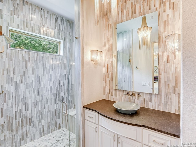 bathroom with an enclosed shower, vanity, and tasteful backsplash