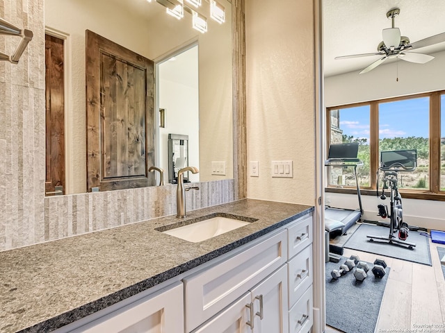 bathroom featuring ceiling fan, hardwood / wood-style floors, and vanity