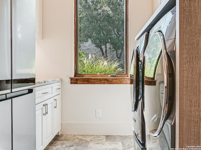 clothes washing area with independent washer and dryer