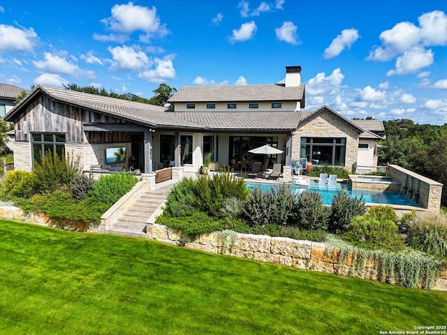 rear view of property featuring a patio area and a lawn