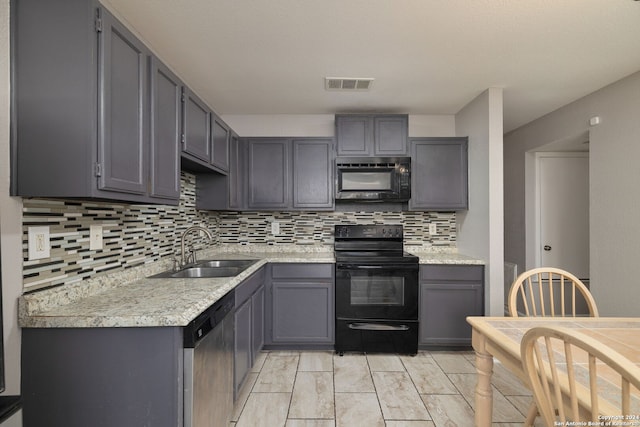 kitchen featuring gray cabinets, black appliances, and sink