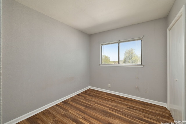 spare room with dark hardwood / wood-style flooring