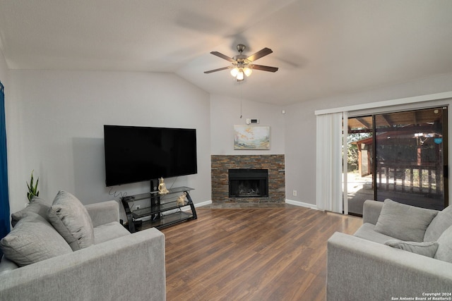 living room with lofted ceiling, a stone fireplace, hardwood / wood-style flooring, and ceiling fan