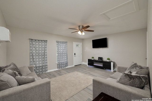 living room with light hardwood / wood-style flooring and ceiling fan