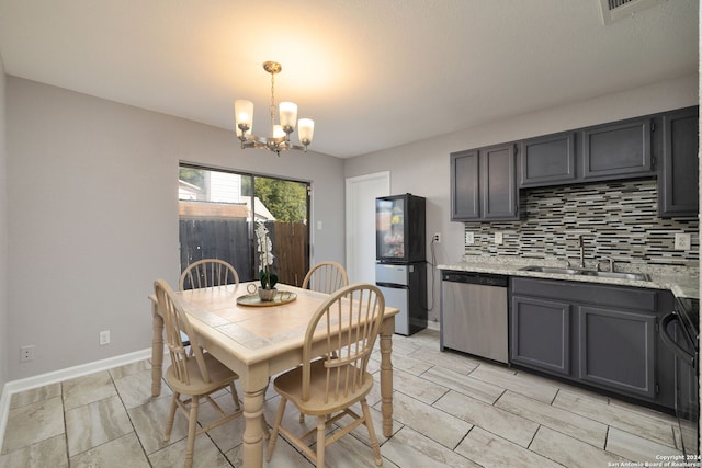 dining area with sink and an inviting chandelier