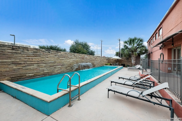 view of swimming pool featuring pool water feature