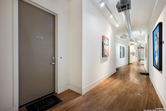 corridor with wood-type flooring