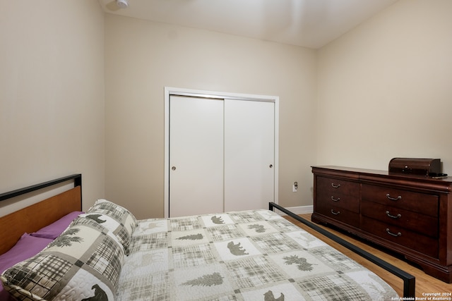 bedroom with light hardwood / wood-style flooring and a closet