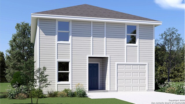 view of front facade with a garage and a front lawn