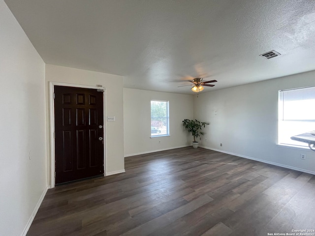 foyer featuring ceiling fan, a textured ceiling, and dark hardwood / wood-style flooring