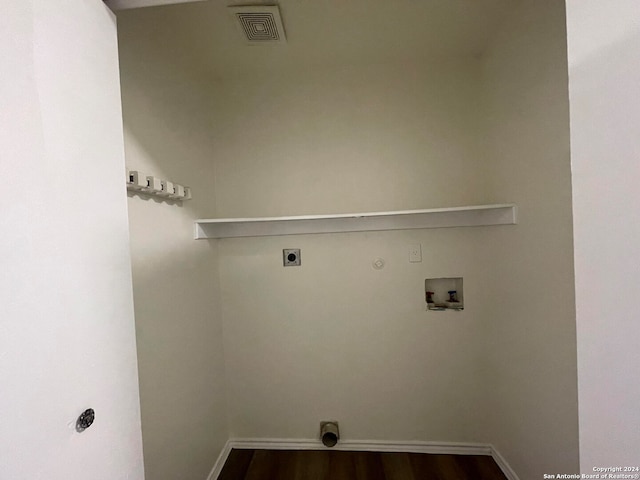 laundry area featuring electric dryer hookup, washer hookup, and dark hardwood / wood-style flooring