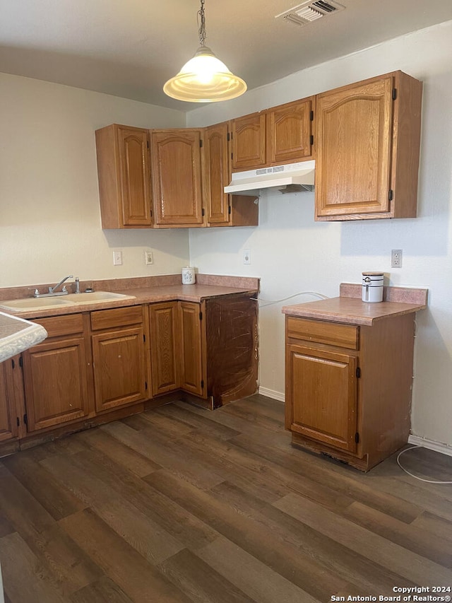 kitchen featuring sink, hanging light fixtures, and dark hardwood / wood-style flooring