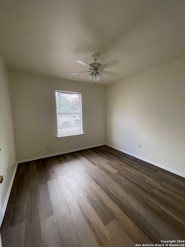 unfurnished room featuring dark hardwood / wood-style floors and ceiling fan