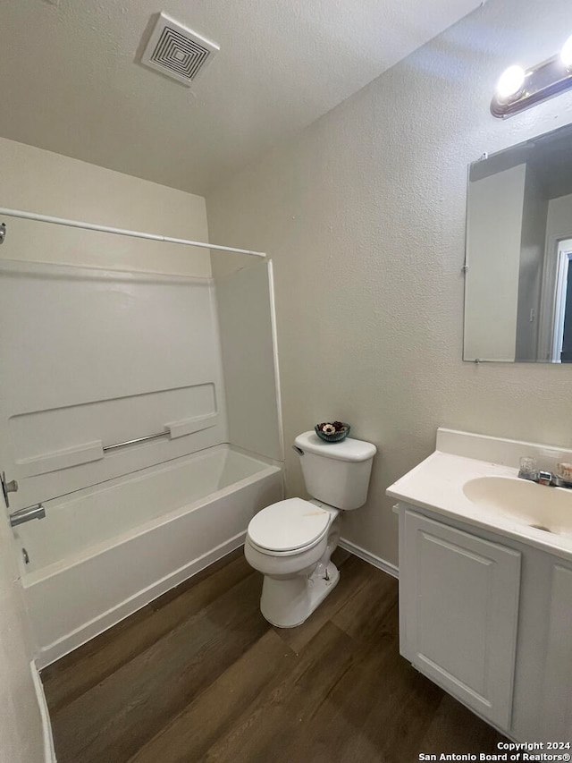 full bathroom with vanity, toilet, wood-type flooring, and shower / tub combination